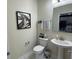 Clean and updated half bathroom with pedestal sink and tile floor at 1445 Olympic Club Blvd, Champions Gate, FL 33896