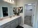 Modern bathroom with vanity, large mirror, and walk-in closet at 1445 Olympic Club Blvd, Champions Gate, FL 33896