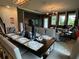 Spacious dining room with large table, seating for eight, and modern lighting at 1445 Olympic Club Blvd, Champions Gate, FL 33896