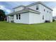 Rear view of two story house with covered patio and large backyard at 1445 Olympic Club Blvd, Champions Gate, FL 33896