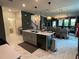 Modern kitchen with island, stainless steel appliances, and breakfast bar at 1445 Olympic Club Blvd, Champions Gate, FL 33896