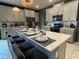Spacious kitchen with gray cabinets, quartz countertops, and breakfast bar at 1445 Olympic Club Blvd, Champions Gate, FL 33896