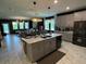 Open concept kitchen with island and views to the living and dining areas at 1445 Olympic Club Blvd, Champions Gate, FL 33896