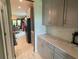 Kitchen with gray cabinets, quartz countertops, and walk-in pantry at 1445 Olympic Club Blvd, Champions Gate, FL 33896