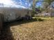 Home's backyard with AC unit and large yard at 1606 Lime St, Kissimmee, FL 34746