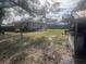 Spacious backyard with large tree and wooden fence at 1606 Lime St, Kissimmee, FL 34746