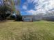 Large backyard with grassy lawn and deck at 1606 Lime St, Kissimmee, FL 34746