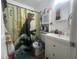 Bathroom featuring a toilet, sink and storage cabinet at 1606 Lime St, Kissimmee, FL 34746