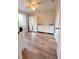 Bright bedroom boasts wood-look floors and ample storage space with white dresser and wardrobe at 1606 Lime St, Kissimmee, FL 34746