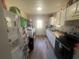 Kitchen with white cabinets and appliances at 1606 Lime St, Kissimmee, FL 34746