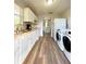 Kitchen features modern appliances, white cabinets, and wood-look flooring at 1606 Lime St, Kissimmee, FL 34746