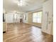 Spacious living room featuring wood-look floors and a cozy dining area at 1606 Lime St, Kissimmee, FL 34746