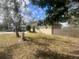 Single story home with side yard and wooden fence at 1606 Lime St, Kissimmee, FL 34746