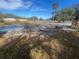 Empty lot with some debris and overgrown grass at 1606 Lime St, Kissimmee, FL 34746