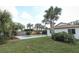 Backyard oasis with pool, lush landscaping, and palm trees at 1710 Aster Dr, Winter Park, FL 32792