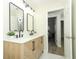 Modern bathroom with double vanity, marble countertop, and black accents at 1710 Aster Dr, Winter Park, FL 32792