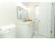 Updated bathroom with white vanity, quartz countertop and a large mirror at 1710 Aster Dr, Winter Park, FL 32792