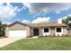 Updated single-story home with a stone facade and a two-car garage at 1710 Aster Dr, Winter Park, FL 32792
