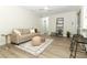 Bright and airy living room with neutral decor and hardwood floors at 1710 Aster Dr, Winter Park, FL 32792