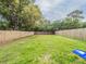 Large backyard with wooden fence and lush green grass at 2419 Rio Pinar Lakes Blvd, Orlando, FL 32822