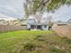 Large grassy backyard with wooden fence and screened patio at 2419 Rio Pinar Lakes Blvd, Orlando, FL 32822
