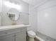 Clean bathroom with gray vanity, subway tile shower, and round mirror at 2419 Rio Pinar Lakes Blvd, Orlando, FL 32822