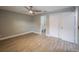 Bright bedroom featuring ceiling fan, wood-look tile floors, and ensuite bath at 2419 Rio Pinar Lakes Blvd, Orlando, FL 32822