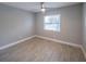 Simple bedroom with ceiling fan and wood-look tile flooring at 2419 Rio Pinar Lakes Blvd, Orlando, FL 32822
