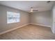 Spacious bedroom with ceiling fan and wood-look tile flooring at 2419 Rio Pinar Lakes Blvd, Orlando, FL 32822