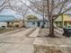 Newly renovated home with a front yard, driveway and large tree at 2419 Rio Pinar Lakes Blvd, Orlando, FL 32822