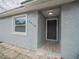 Newly renovated house exterior, featuring a gray facade and a modern front door at 2419 Rio Pinar Lakes Blvd, Orlando, FL 32822