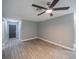 Spacious living room with wood-look tile flooring and ceiling fan at 2419 Rio Pinar Lakes Blvd, Orlando, FL 32822