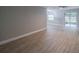 Bright living room with wood-look tile floors and access to patio at 2419 Rio Pinar Lakes Blvd, Orlando, FL 32822