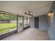 Relaxing screened porch with ceiling fan and wood-look tile floor at 2419 Rio Pinar Lakes Blvd, Orlando, FL 32822