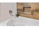 Clean bathroom with a bathtub and stylish tile work at 2634 Sunrise Shores Dr, Kissimmee, FL 34747