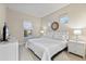 Main bedroom with a king-size bed, nightstands, and a large window at 2634 Sunrise Shores Dr, Kissimmee, FL 34747