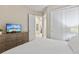 Comfortable bed and dresser with TV at 2634 Sunrise Shores Dr, Kissimmee, FL 34747