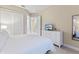 Bedroom with king-size bed, white dresser, and large mirror at 2634 Sunrise Shores Dr, Kissimmee, FL 34747