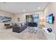 Open living space with gray sectional sofa and large TV at 2634 Sunrise Shores Dr, Kissimmee, FL 34747