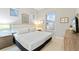 King-size bed, TV, and neutral color scheme at 2634 Sunrise Shores Dr, Kissimmee, FL 34747
