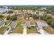 Aerial view showing a single-Gathering house, its neighborhood, and nearby lake at 2649 Howland Blvd, Deltona, FL 32738