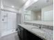 Modern bathroom with granite double vanity and a walk-in shower at 2649 Howland Blvd, Deltona, FL 32738