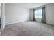 Simple bedroom with gray carpet and neutral walls, featuring a window at 2649 Howland Blvd, Deltona, FL 32738