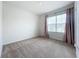 Simple bedroom with neutral carpeting and window coverings at 2649 Howland Blvd, Deltona, FL 32738