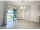 Dining room with sliding glass doors to backyard and stylish chandelier at 2649 Howland Blvd, Deltona, FL 32738