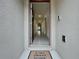 Open door revealing a bright hallway with tile floors at 2649 Howland Blvd, Deltona, FL 32738