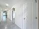 Long hallway with tile floors and doors to other rooms at 2649 Howland Blvd, Deltona, FL 32738