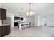 Eat-in kitchen with island seating, dark cabinetry, and stainless steel appliances at 2649 Howland Blvd, Deltona, FL 32738