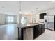 Open concept kitchen with an island and stainless steel appliances at 2649 Howland Blvd, Deltona, FL 32738
