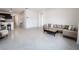 Open living room with tile floors, neutral color palette, and a modern sectional sofa at 2649 Howland Blvd, Deltona, FL 32738